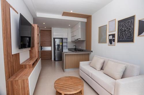 a living room with a white couch and a kitchen at Exclusive condo with spectacular SEA VIEW! in Santa Marta