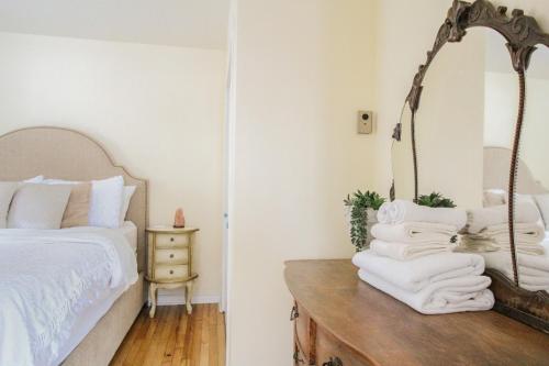 a bedroom with a bed and a mirror on a table at Sunrise and Bayview with SNOW SHOES, WATERCRAFTS , BIKES in Meaford