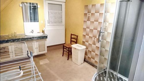 a bathroom with a sink and a shower at Maison confortable à Saint-Laurent-de-Cuves avec jardin in Saint-Laurent-de-Cuves