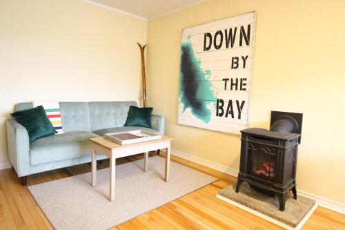 a living room with a couch and a wood stove at Sunrise and Bayview with SNOW SHOES, WATERCRAFTS , BIKES in Meaford