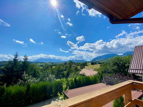 a view of the mountains from the deck of a house at Mountain View PM in Poiana Mărului