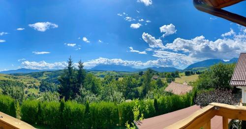 a view of the mountains from the balcony of a house at Mountain View PM in Poiana Mărului