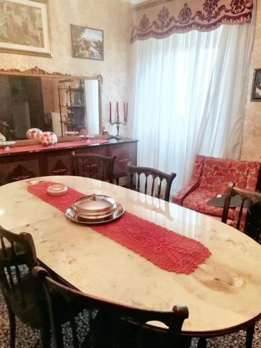 a dining room table with a red napkin on it at Charming House in Barbarano Romano with Terrace and Fireplace in Barbarano Romano
