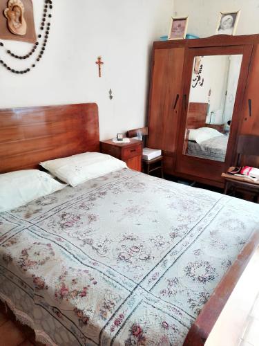 a bedroom with a large bed and a mirror at Charming House in Barbarano Romano with Terrace and Fireplace in Barbarano Romano