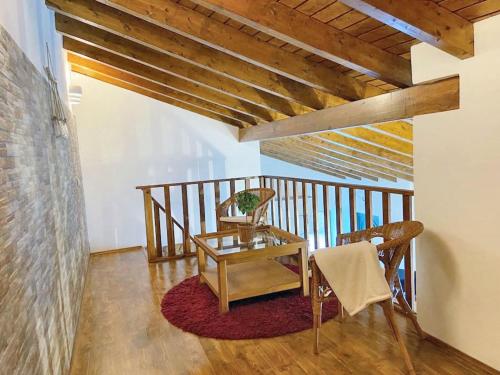 a room with a table and chairs on a balcony at Charming House in Barão de São Miguel in Barão de São Miguel