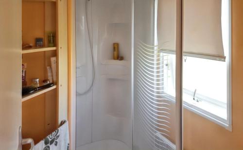 a shower with a glass door in a bathroom at Charming Bungalow in Pataias with Shared Pool in Pataias