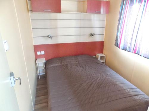 a small bedroom with a bed in a room at Charming Bungalow in Pataias, 18 m² with Shared Pool. in Pataias