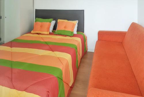 a bedroom with a bed and a couch at Charming Bungalow in Pataias with Shared Pool in Pataias