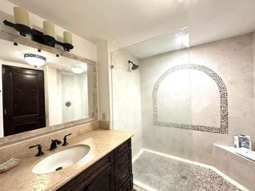 a bathroom with a sink and a large mirror at 2BD Exclusive Cabo Corridor Beach Front Luxury in San José del Cabo