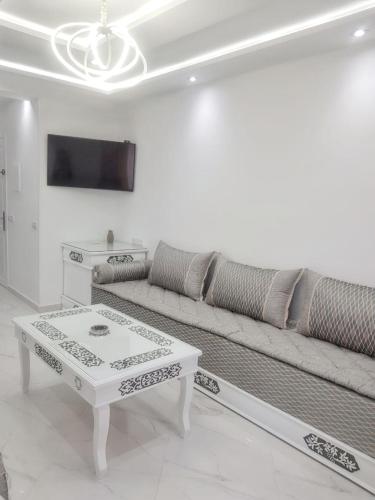 a living room with a couch and a coffee table at Bright apartment in Marina Smir, sea view and shared pool in Marina Smir