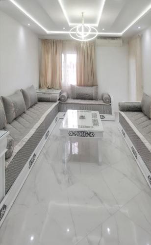 a living room with couches and a coffee table at Bright apartment in Marina Smir, sea view and shared pool in Marina Smir