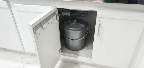 a trash can in the middle of a kitchen cabinet at Bright apartment in Marina Smir, sea view and shared pool in Marina Smir