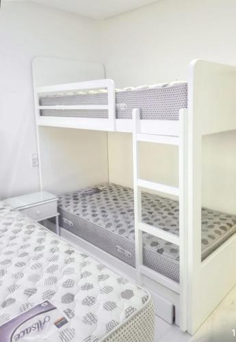 a bedroom with two bunk beds and a ladder at Bright apartment in Marina Smir, sea view and shared pool in Marina Smir