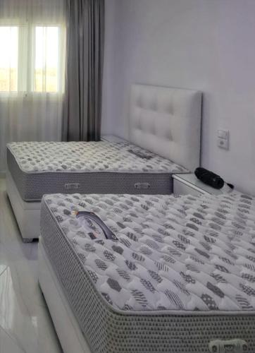 two mattresses in a bedroom with two beds at Bright apartment in Marina Smir, sea view and shared pool in Marina Smir