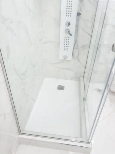 a shower with a glass enclosure with a controller in it at Bright apartment in Marina Smir, sea view and shared pool in Marina Smir