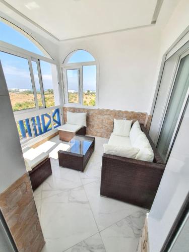 a living room with a couch and a table at Bright apartment in Marina Smir, sea view and shared pool in Marina Smir