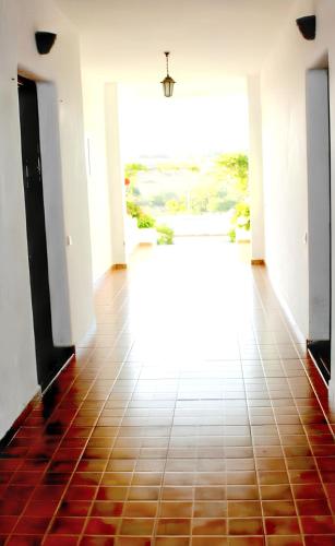 a hallway with a tile floor and a large window at Bright apartment in Marina Smir, sea view and shared pool in Marina Smir