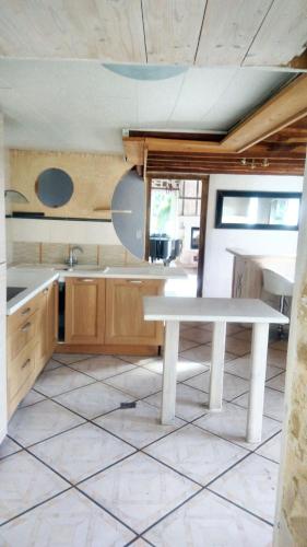 - une cuisine avec une table blanche dans une pièce dans l'établissement Maison de charme à Gan avec vue sur la montagne, à Gan