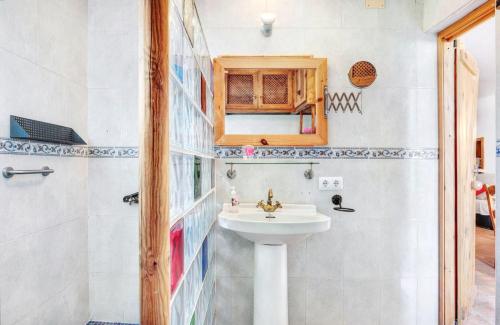 a bathroom with a sink and a mirror at Spacious House with Private Pool El Soto in El Cañal