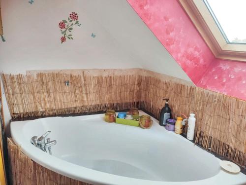 a bathroom with a bath tub with a sink at Cozy Apartment in Estinnes – 40 sqm with a fenced garden. in Estinnes-au-Val