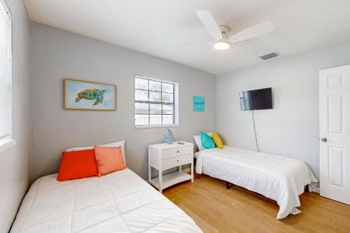 a bedroom with two beds and a ceiling fan at My Seaside Escape in Bradenton