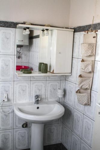 a bathroom with a sink and a mirror at VILA SOFi in Néa Karyá