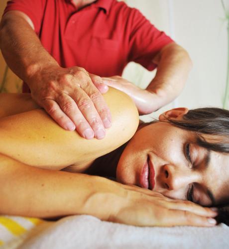 a woman getting a massage from a therapist at Sporthotel Kirchler in Tux