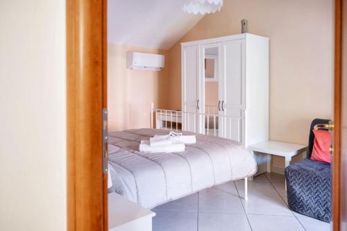 a bedroom with a bed and a cabinet and a chair at Comfortable apartment in Gragnano 45 m² with quiet balcony in Castello