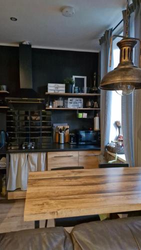 a kitchen with a wooden table in a room at Yu&Yu loft apartment in Rīga