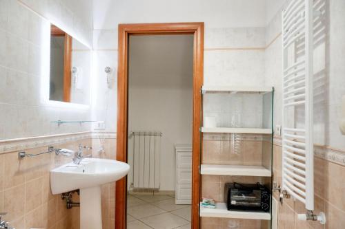 a bathroom with a sink and a toilet and a mirror at Comfortable apartment in Gragnano 45 m² with quiet balcony in Castello