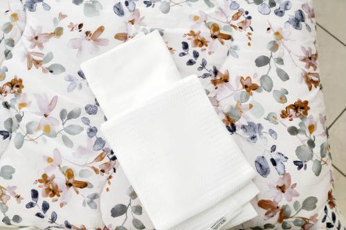 an open book on a floral dress with a notebook at Comfortable apartment in Gragnano 45 m² with quiet balcony in Castello