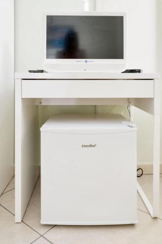 a white desk with a tv on top of it at Comfortable apartment in Gragnano 45 m² with quiet balcony in Castello
