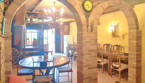 a dining room with a table and chairs and a clock at Spacious villa with private pool in La Puebla de Castro in La Puebla de Castro