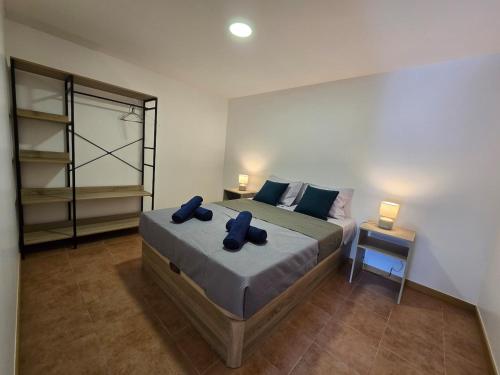 a bedroom with a bed with two pillows on it at Autonomia House IV in Câmara de Lobos
