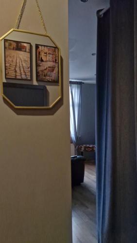 a room with two pictures hanging on a wall at Yu&Yu loft apartment in Rīga