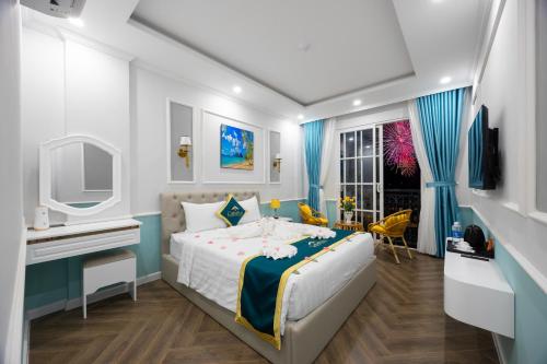 a bedroom with a bed and a desk and a tv at Catarina Hotel Phu Quoc - Free Cable Car Ticket & Hon Thom Water Park in Phu Quoc