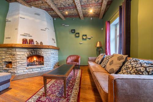 a living room with a couch and a fireplace at Old Town - Dunkri Apartment in Tallinn