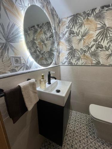 a bathroom with a sink and a mirror at Emilysuites - Malaga Centro Historico in Málaga