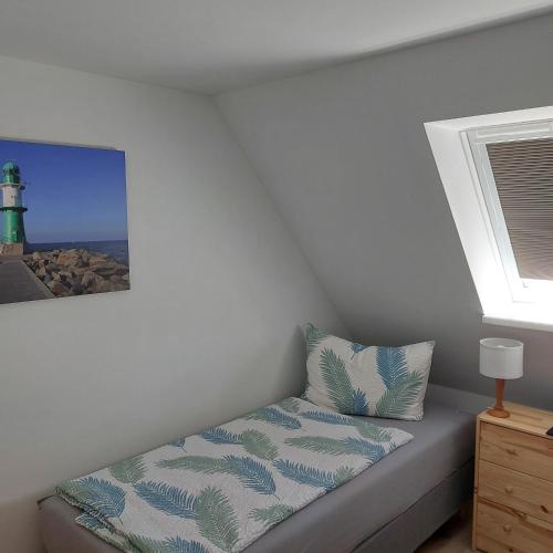 a bed in a room with a lighthouse at Klosterblick in Bad Doberan