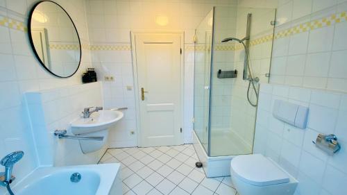 a bathroom with a sink and a toilet and a shower at 8 Personen I BBQ I Sunset in Herrsching am Ammersee