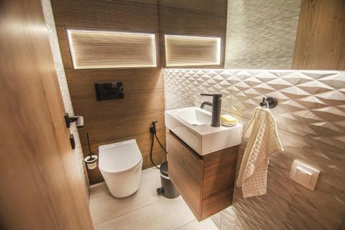 a bathroom with a sink and a toilet at Lithos House & Spa in Nafpaktos
