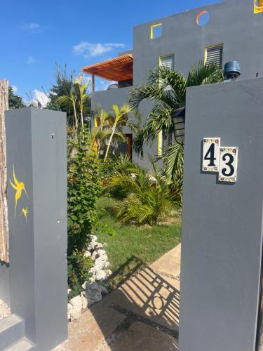 a house with a gate with the number on it at The Bakers Villa Old Wharf Ltd in Treasure Beach