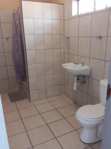 a bathroom with a toilet and a sink at OrbanLife Lite Keetmanshoop in Keetmanshoop