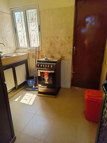 a kitchen with an oven in the middle of a room at AMAL HoME in Ouagadougou