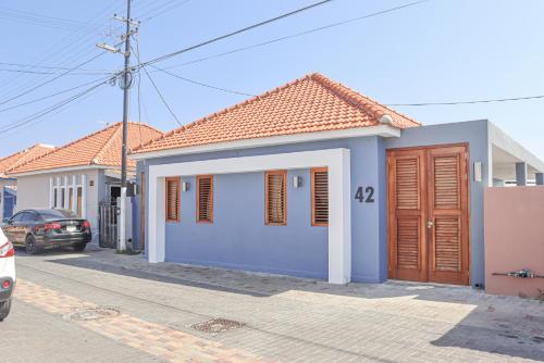 a blue and white house on a street at Sapphire Residence in Willemstad