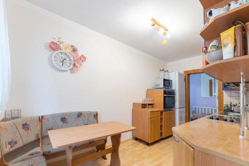 a kitchen with a couch and a table in a room at Domeček na samotě in Terezín