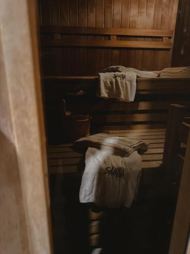 a room with two beds with white towels on them at Strandhotel Strande in Strande
