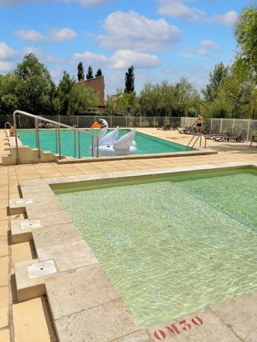 une piscine avec un toboggan au milieu dans l'établissement Maison confortable Saint-Saturnin, à Saint-Saturnin-lès-Avignon