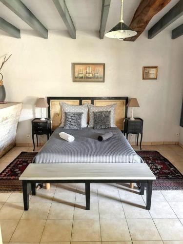a bedroom with a large bed in a room at Maison de charme à Sigogne, proche de Cognac, barbecue inclus. in Sigogne