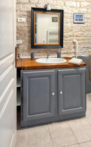a bathroom with a sink and a mirror at Maison de charme à Sigogne, proche de Cognac, barbecue inclus. in Sigogne